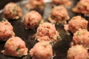 Pan frying the meatballs in cast iron skillet